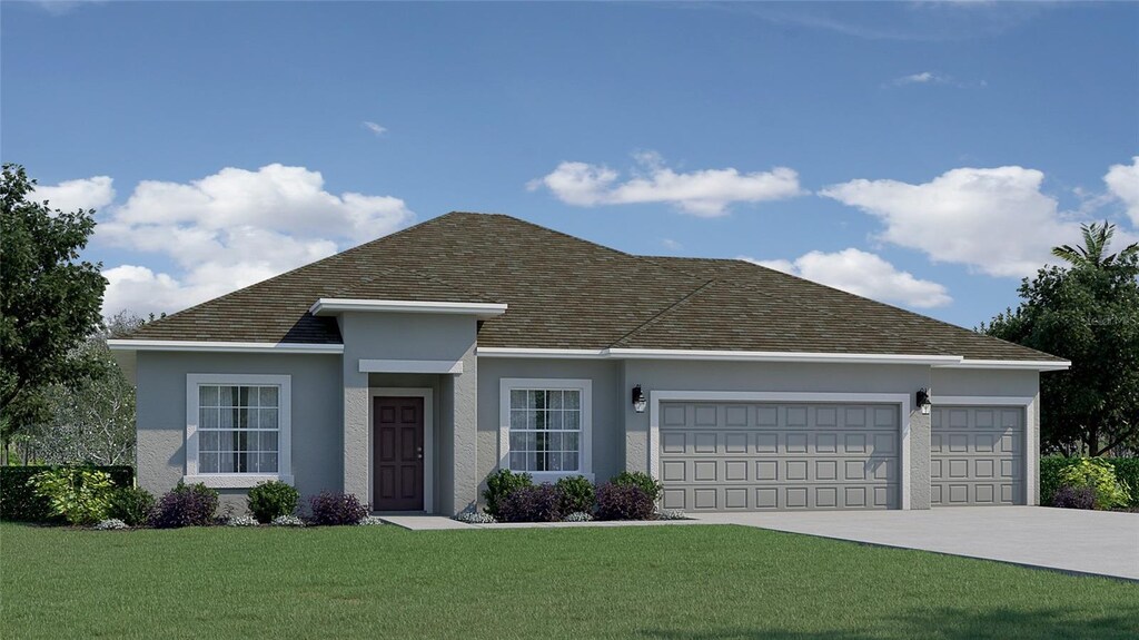 view of front of property with a garage and a front yard