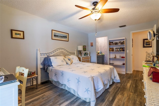 bedroom featuring a textured ceiling, ceiling fan, and dark hardwood / wood-style floors