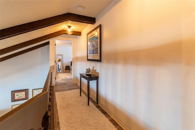 corridor with hardwood / wood-style flooring and lofted ceiling with beams