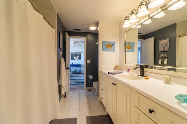 bathroom with vanity, toilet, tile patterned floors, and ceiling fan