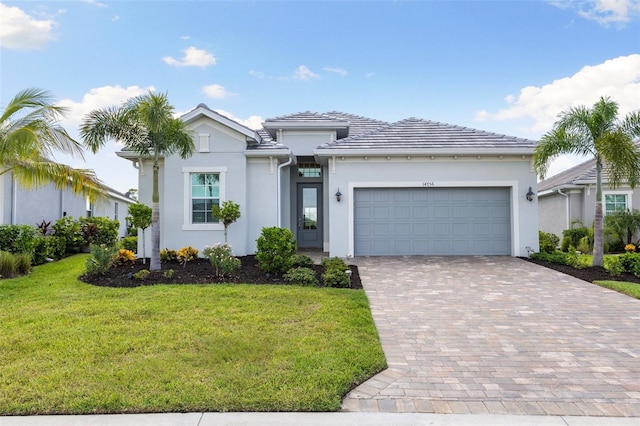 view of front of property featuring a garage and a front yard