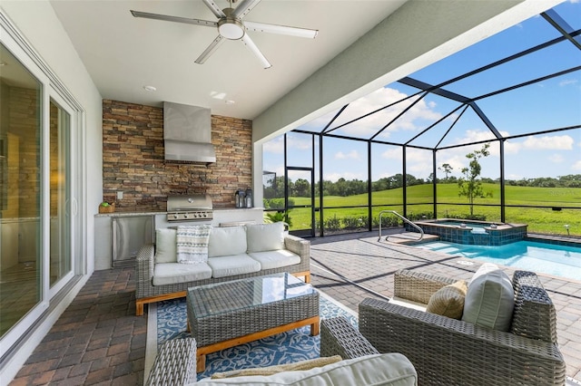 view of patio / terrace with exterior kitchen, glass enclosure, area for grilling, an outdoor hangout area, and an in ground hot tub