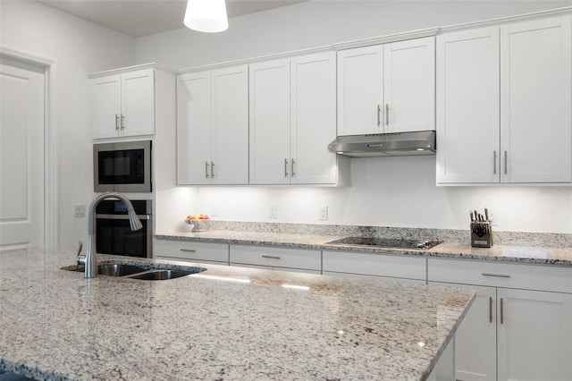 kitchen with black electric cooktop, white cabinetry, built in microwave, sink, and light stone countertops