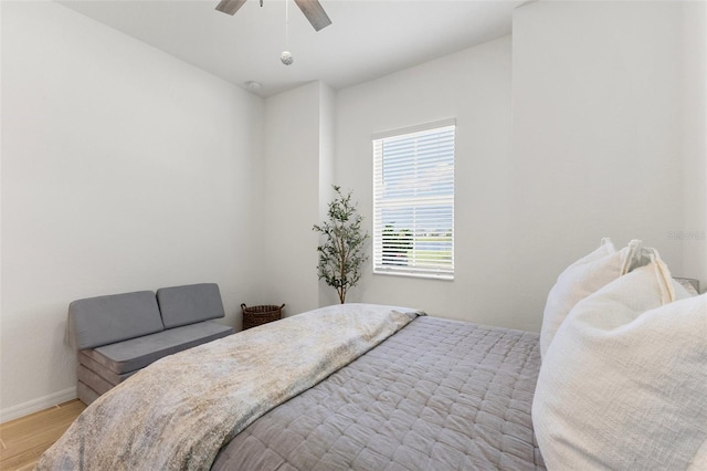 bedroom with light hardwood / wood-style flooring and ceiling fan