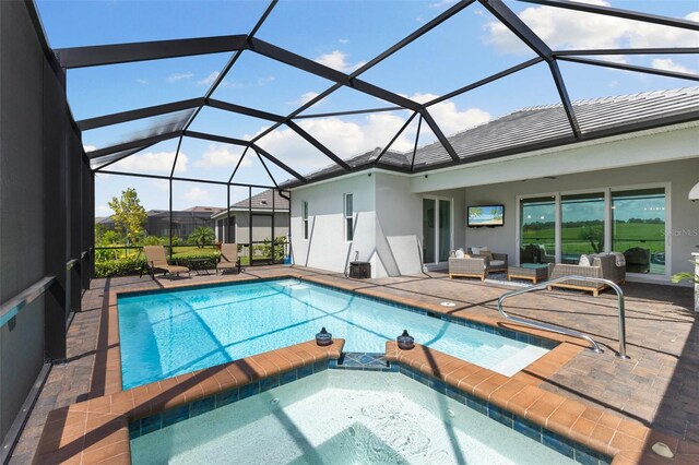 view of pool featuring an in ground hot tub, a lanai, a patio, and an outdoor living space