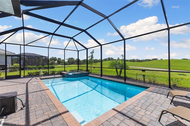 view of swimming pool featuring an in ground hot tub, a patio, a yard, and a lanai