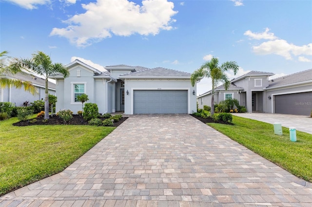 view of front of property featuring a garage and a front lawn