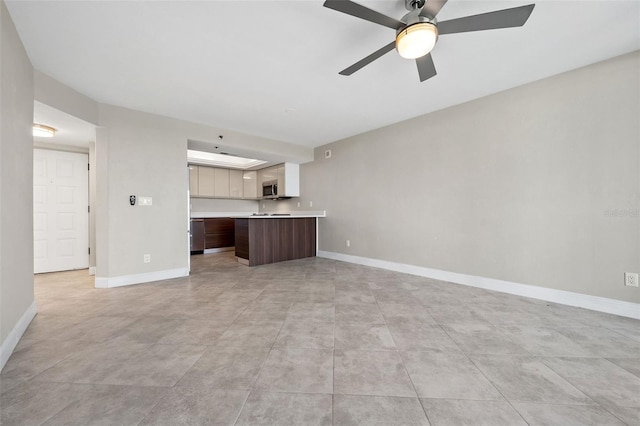 unfurnished living room featuring light tile patterned flooring and ceiling fan