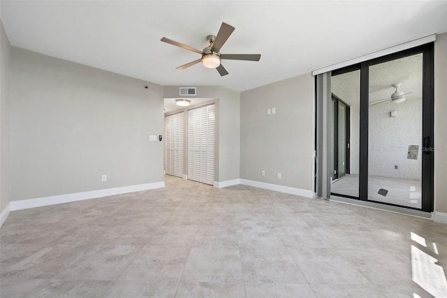 spare room with ceiling fan and tile patterned floors