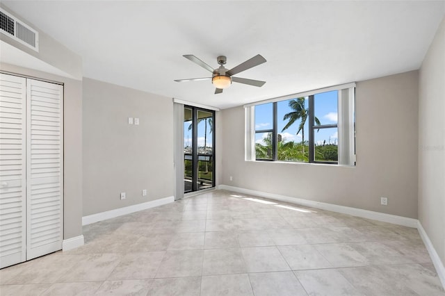 unfurnished bedroom with access to exterior, a closet, ceiling fan, and light tile patterned floors