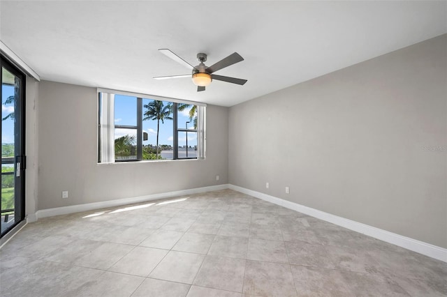 spare room featuring light tile patterned flooring and ceiling fan