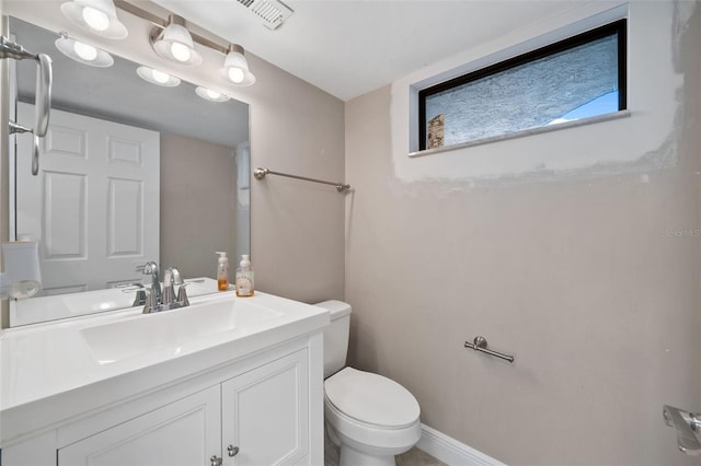 bathroom with toilet and vanity