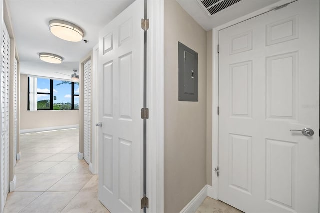 hallway with light tile patterned flooring and electric panel