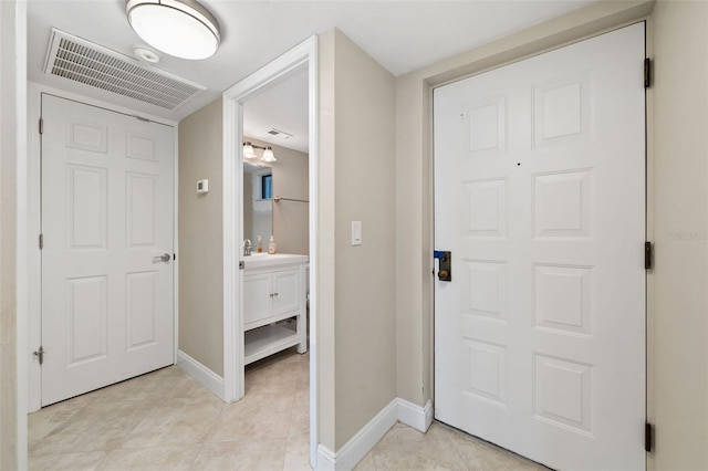 corridor with light tile patterned flooring