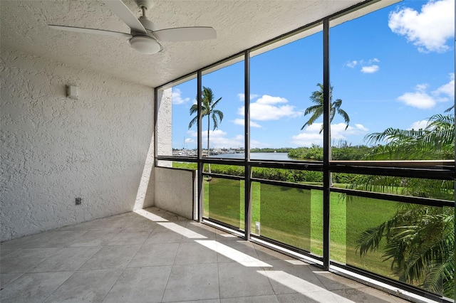 unfurnished sunroom featuring plenty of natural light and ceiling fan