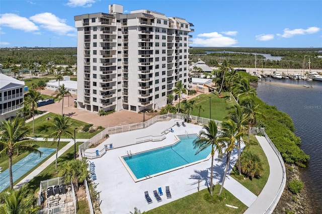 view of swimming pool featuring a patio area and a water view