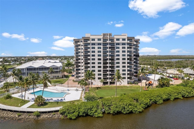 exterior space with a water view and a community pool