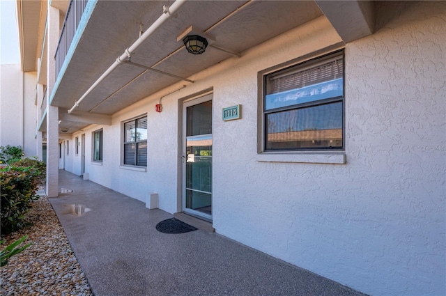 view of exterior entry with a patio