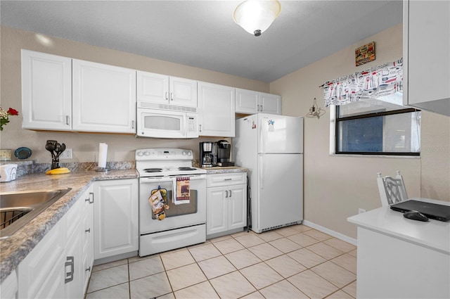 kitchen featuring white cabinetry and white appliances