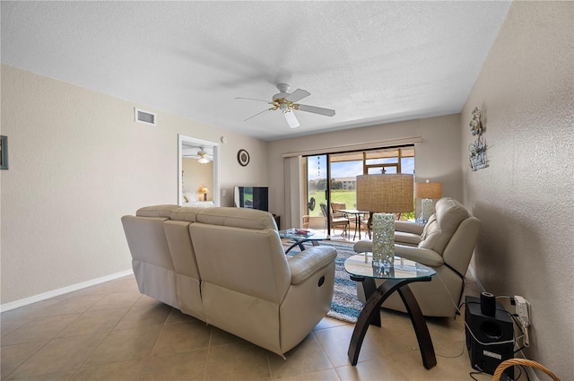 tiled living room featuring a textured ceiling and ceiling fan