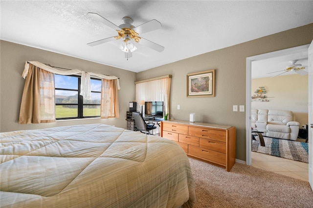 bedroom with light carpet, a textured ceiling, and ceiling fan