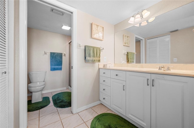 bathroom with vanity, tile patterned flooring, and toilet