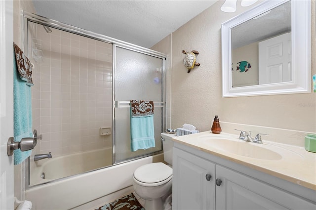 full bathroom with vanity, a textured ceiling, shower / bath combination with glass door, and toilet