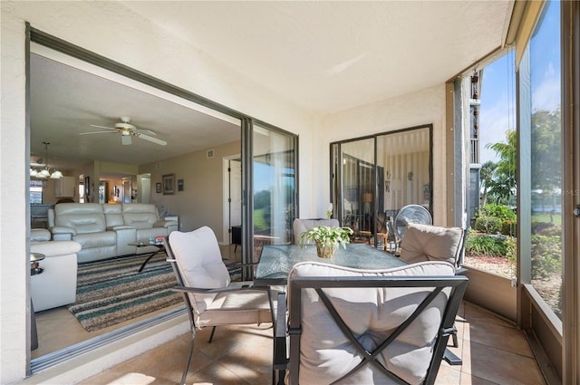 sunroom featuring ceiling fan