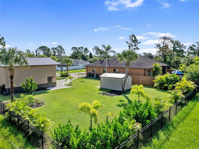 view of yard with a fenced backyard and an outdoor structure