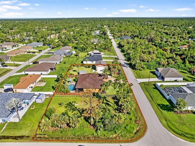 bird's eye view featuring a wooded view and a residential view