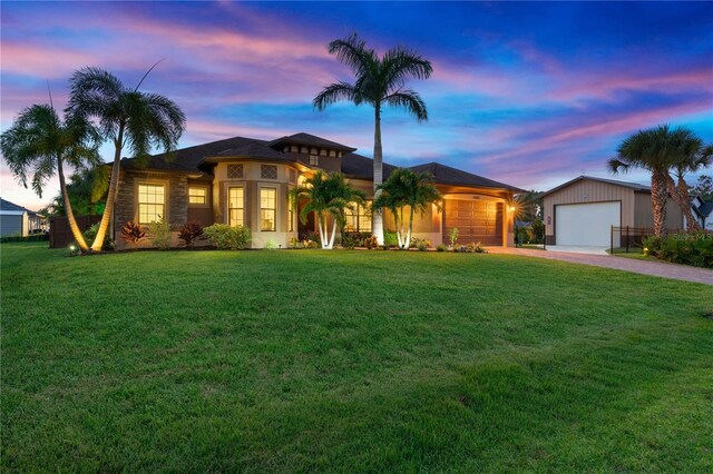 view of front of home with driveway and a front lawn