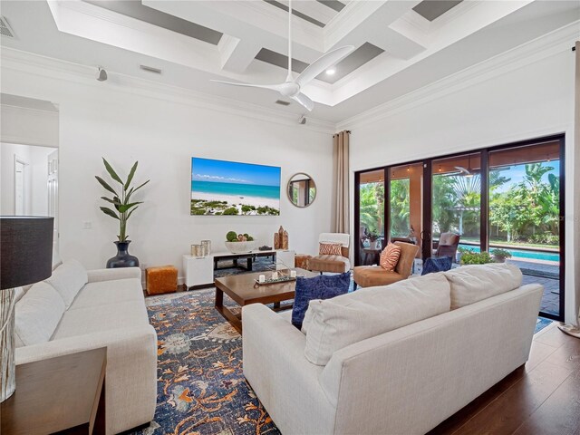 living area with coffered ceiling, a towering ceiling, dark wood-style floors, ceiling fan, and crown molding