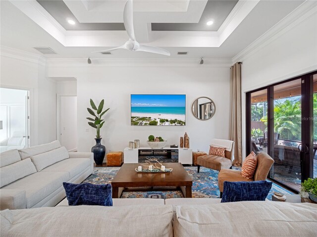 living area featuring visible vents, a high ceiling, and ornamental molding