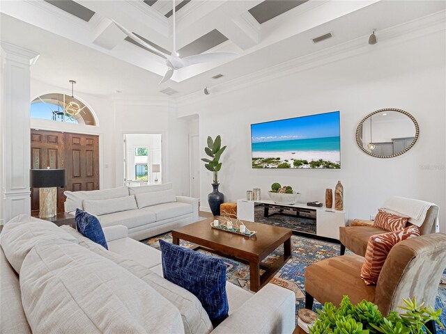 living area with ornamental molding, beamed ceiling, coffered ceiling, and visible vents