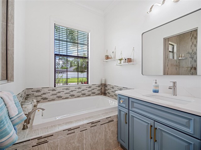 full bath with a garden tub, crown molding, and vanity