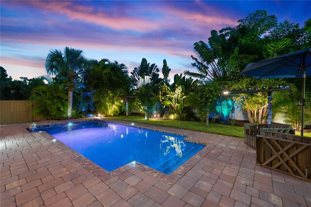 view of pool with a fenced in pool, a patio area, and fence