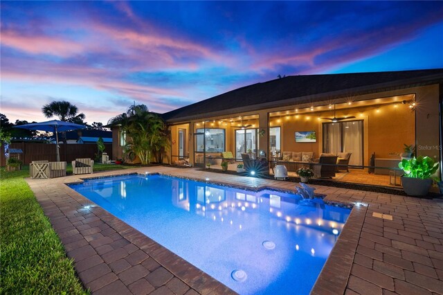 view of swimming pool with a fenced in pool, a ceiling fan, a patio, and fence