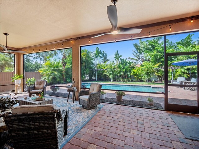 sunroom / solarium with ceiling fan and plenty of natural light