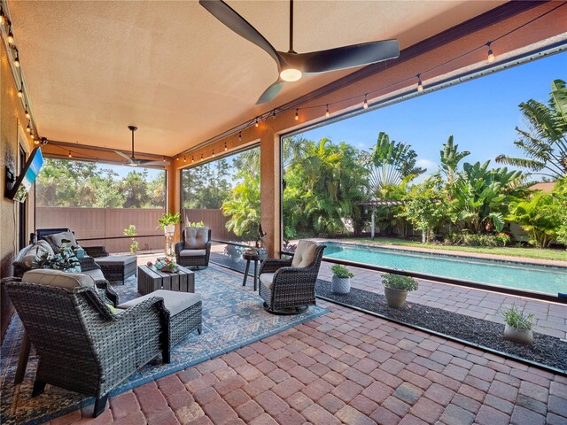 view of patio featuring ceiling fan, a fenced backyard, an outdoor living space, and a fenced in pool