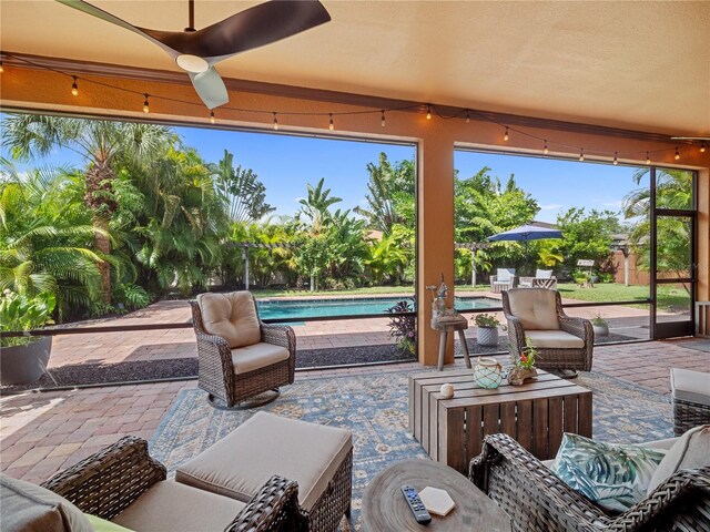 view of patio with outdoor lounge area, an outdoor pool, and a ceiling fan