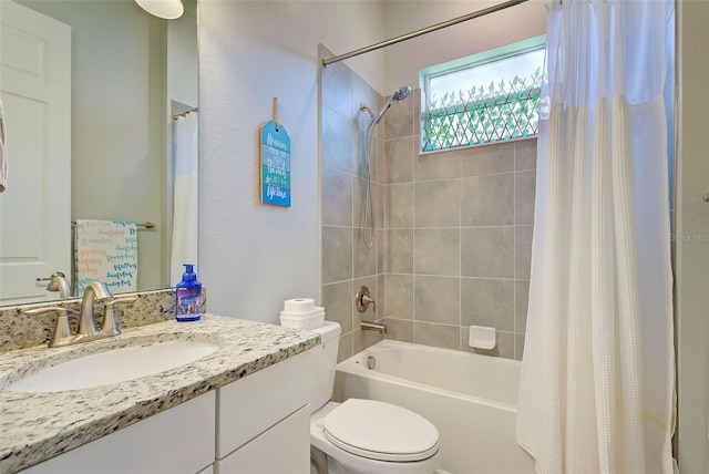 full bathroom featuring shower / tub combo with curtain, vanity, and toilet