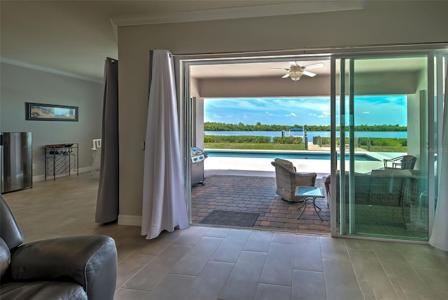 doorway featuring ornamental molding, a water view, and ceiling fan