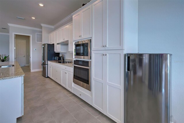 kitchen featuring sink, ornamental molding, appliances with stainless steel finishes, light stone countertops, and white cabinets