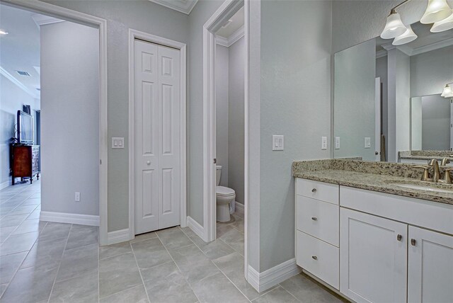 bathroom with vanity, tile patterned floors, ornamental molding, and toilet