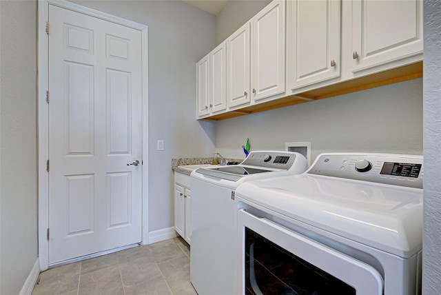 washroom with cabinets, sink, and independent washer and dryer