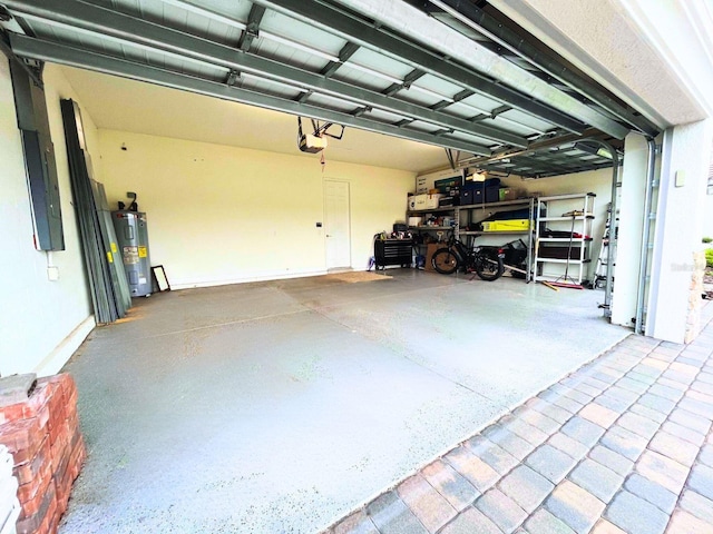 garage with a garage door opener and electric water heater