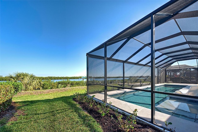 view of swimming pool with a water view, glass enclosure, and a lawn