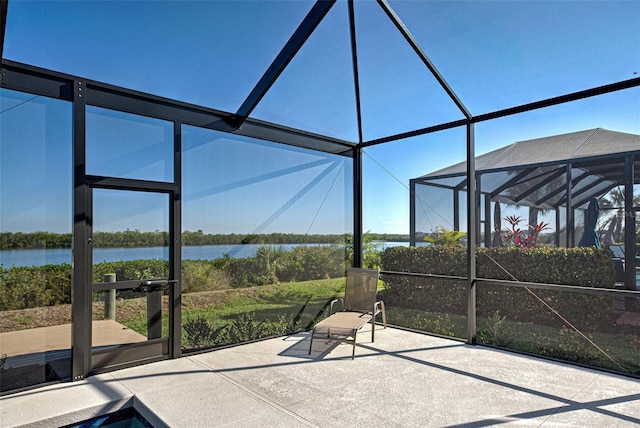 unfurnished sunroom featuring a water view