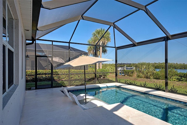 view of pool featuring a patio and glass enclosure