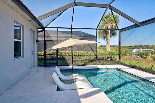 view of pool featuring a lanai and a patio